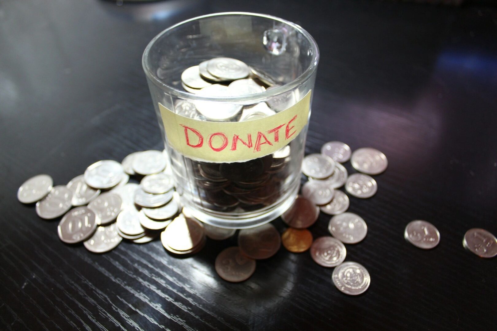 A glass of water with coins in it