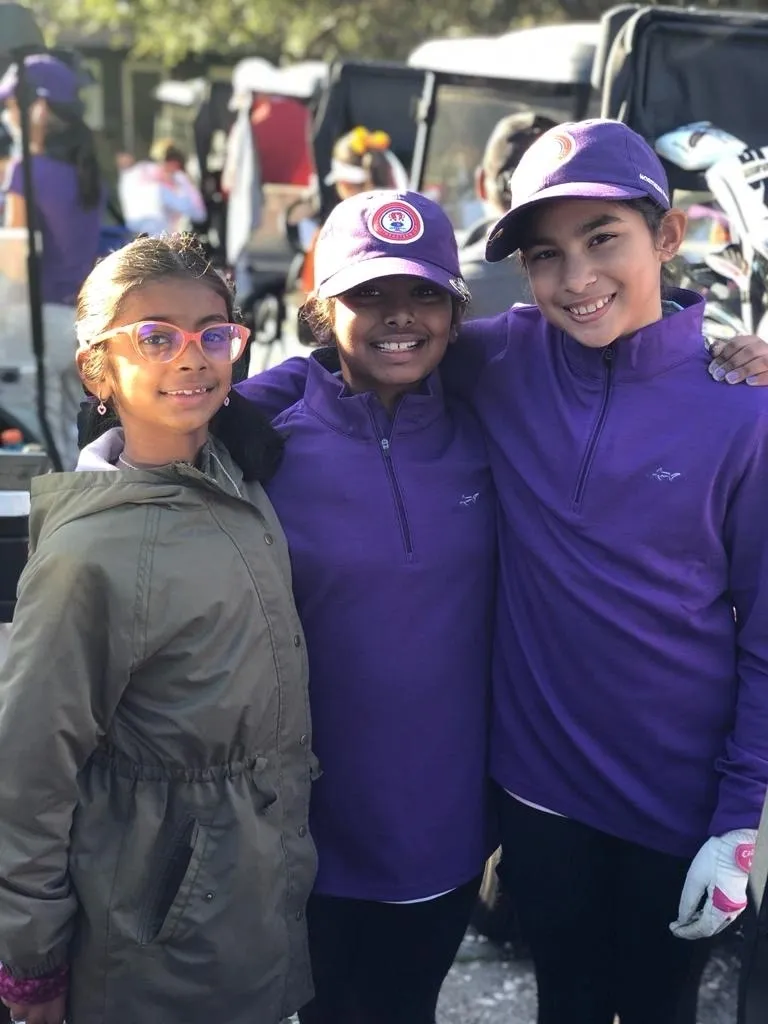 Three young people are posing for a picture.